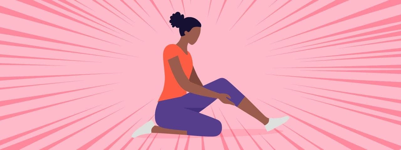 A picture of a lady sitting/kneeling on the floor holding one of her outstretched legs due to muscle spasms.